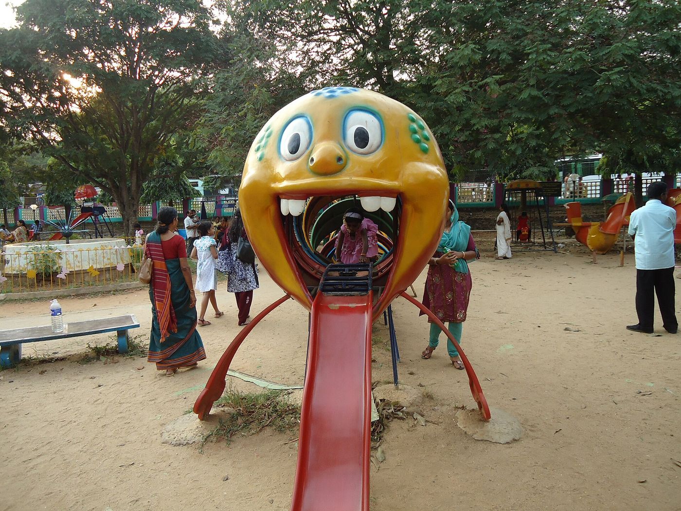 Children playing on a slide in a park